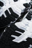 The black and white sole of trendy sports sneakers is a close-up in full screen. photo