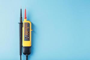Yellow voltage indicator on a blue background photo