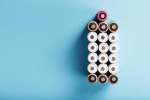 AA finger batteries in the form of a large battery on a blue background. photo