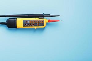 Yellow voltage indicator on a blue background photo