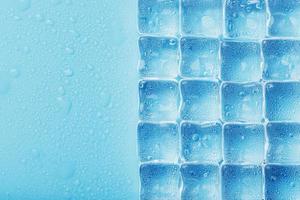 Background of ice cubes with drops in blue color in full screen photo