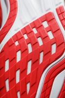 Running shoes with red soles on a black background. photo