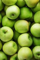 Background of ripe and juicy green apples, perspective from above. photo