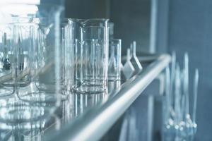 Laboratory glass flasks and test tubes on a rack. photo