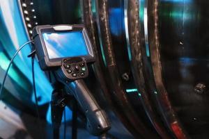 Borescope camera display on a tripod located at the turbine, Inspection of internal parts of a jet engine. photo