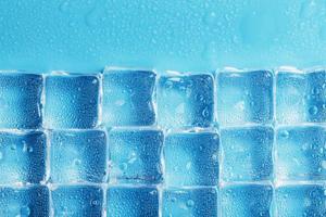 Background of ice cubes with drops in blue color in full screen photo