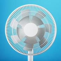 A high-tech white electric fan with a modern design for cooling the room on a blue background photo