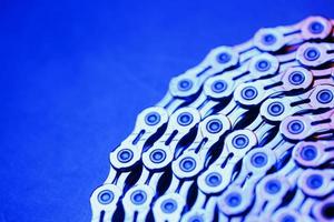 The texture of a Shiny bicycle chain with blue-purple backlight photo