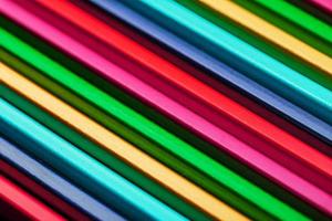 A set of colorful pencils on a textured dark background photo