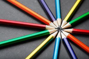 Multicolored pencils in the shape of a star on a black background. photo