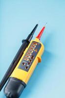 Yellow voltage indicator on a blue background photo