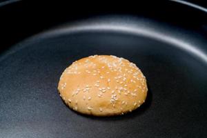 hamburger bun in frying teflon pan for cooking,homemade photo