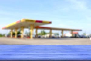 top desk with blur fueling station background,wooden table photo