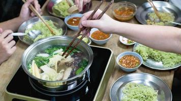 party eating sukiyaki in home photo