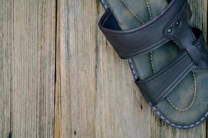 closeup brown leather slippers on wood background,top view photo