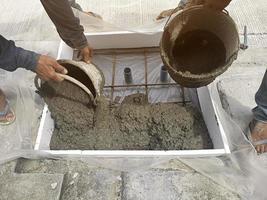 Pouring the mortar by pouring the ready-mixed concrete onto the wire mesh photo