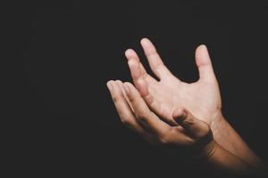 Close up Asian christian woman hands person pray and worship for thank god in church with black background, The concept for faith, spirituality and religion photo