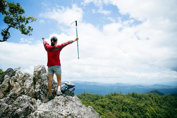 Young person hiking female standing on top rock, Backpack woman looking at  beautiful mountain valley at sunlight in summer, Landscape with sport girl,  high hills, forest, sky. Travel and tourism. 10266232 Stock