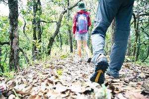 Young tourist couple walking spectacular mountain scenery in high mountains. man and woman hiker on top rock. A couple of travelers in love. People greet the dawn. Lovers travel. Copy space photo