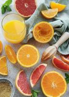 Glass of juice and citrus fruits photo