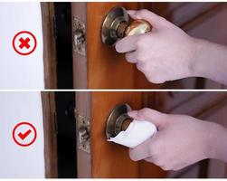 Young Asian woman adult opening door with clean tissue on the knob handle instead of hand, concept of antibacterial, virus prevention, close up. photo