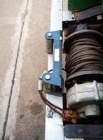 Old sling cable of electric winch in front of 4wd car photo