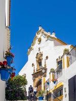 ESTEPONA, ANDALUCIA, SPAIN - MAY 5. Church of Nuestra Senora de los Remedios in Estepona Spain on May 5, 2014. Two unidentified people. photo