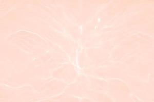 Defocus blurred transparent pink colored clear calm water surface texture with splash, bubble. Shining pink water ripple background. Surface of water in swimming pool. Tropical pink water textures. photo