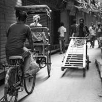 Old Delhi, India, April 15, 2022 - Unidentified group of men walking the streets of Old Delhi, Street Photography of Chandni Chowk market of Old Delhi during morning time, Old Delhi Street Photography photo