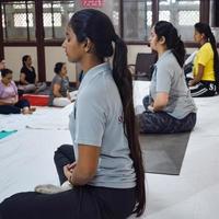 New Delhi, India, June 19 2022 -Group Yoga exercise session for people of different age groups in Balaji Temple, Vivek Vihar, International Yoga Day, Big group of adults attending yoga class in temple photo