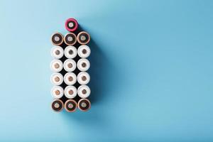 AA finger batteries in the form of a large battery on a blue background. photo