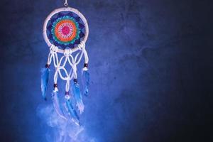 Dream catcher on a dark background with smoke and purple light