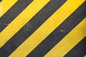 Old Iron Warehouse Wall Background With Black And Yellow Pattern photo