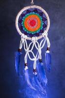 Dream catcher on a dark background with smoke and purple light