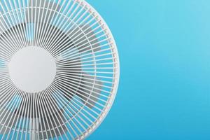 Electric fan in white with a modern design for cooling the room on a blue background photo