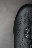 Part of Shoes made of black perforated leather close-up. photo