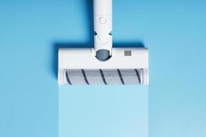 A vacuum cleaner nozzle with a clean stripe on a blue background. photo