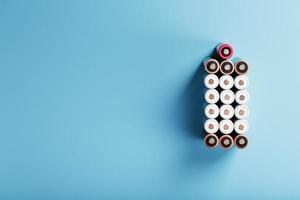 AA batteries are arranged in the form of a large battery on a blue background. photo