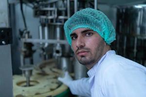 Product quality control officer in fruit juice production line Carry out an inspection of bottles used to contain fruit juices photo