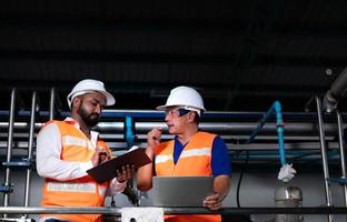 Chief engineer of a mechanical plant Inspecting and explaining the maintenance of the machine to the mechanic photo