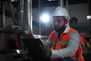 Engineer of the Mechanical Plant Conduct inspection of the sterilization machine tunnel. To check the working condition of the machine to be ready photo