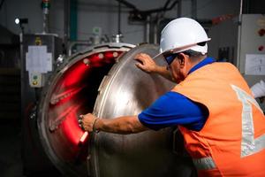 Engineer of the Mechanical Plant Conduct inspection of the sterilization machine tunnel. To check the working condition of the machine to be ready photo