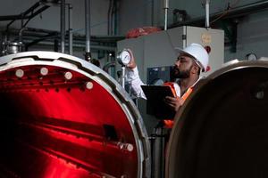 Chief Engineer of the Mechanical Plant Conduct inspection of the sterilization machine tunnel. To check the working condition of the machine to be ready photo