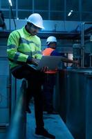 Chief Engineer of the Mechanical Plant Inspecting machine maintenance with factory technicians photo