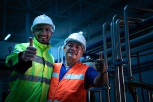 Chief Engineer of the Mechanical Plant Inspecting machine maintenance with factory technicians photo