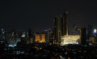 Night view of Bangkok, Thailand, filled with many tall buildings photo
