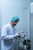 Product quality control officer in fruit juice production line Carry out an inspection of bottles used to contain fruit juices photo