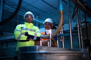 Chief Engineer of the Mechanical Plant Inspecting machine maintenance with factory technicians photo