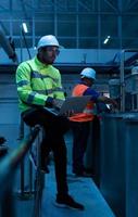 Chief Engineer of the Mechanical Plant Inspecting machine maintenance with factory technicians photo