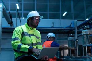 Chief Engineer of the Mechanical Plant Inspecting machine maintenance with factory technicians photo